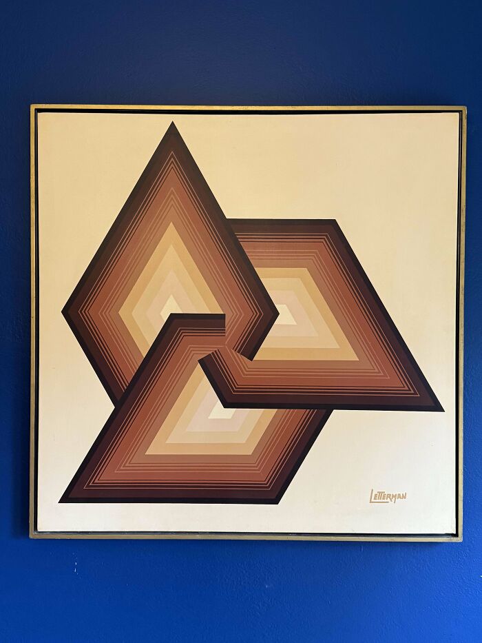 Mid-century design wall art with geometric shapes in warm brown tones, showcasing effortless vintage charm on a blue wall.