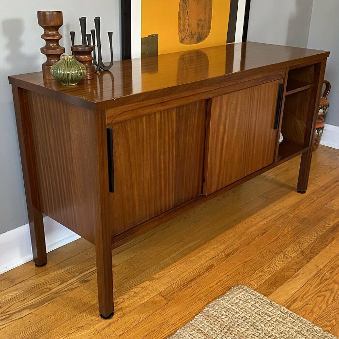 Mid-century wooden sideboard with vintage decor pieces, showcasing timeless mid-century designs and effortless vintage charm.