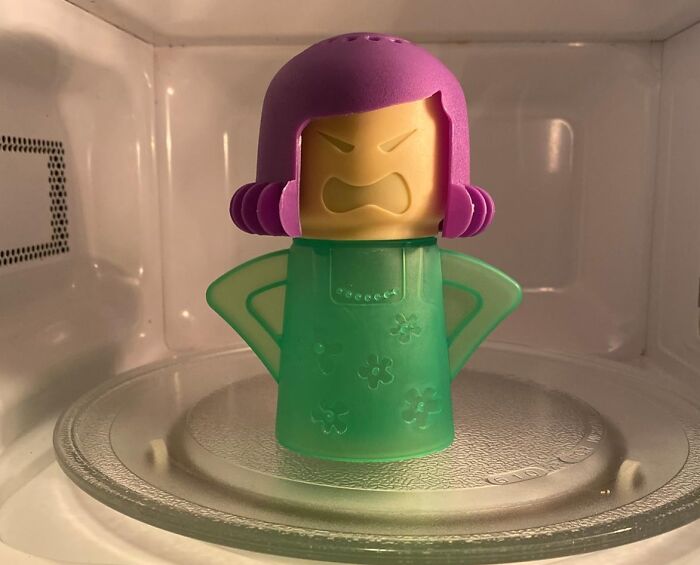 Funny kitchen gadget shaped like an angry woman in a microwave, combining humor with practical kitchen use.