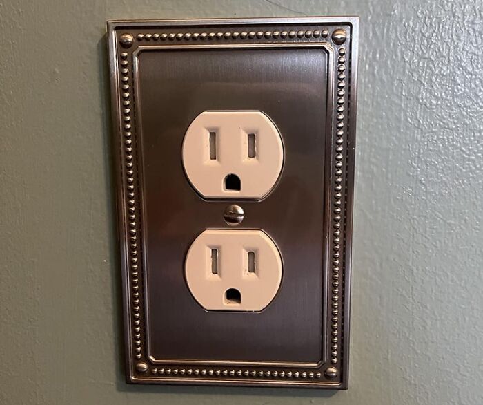 Decorative electrical outlet with bronze cover plate installed as a quick home upgrade for weekend wins projects.