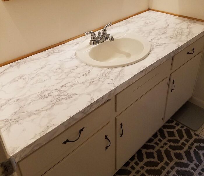 Bathroom countertop home upgrade with marble finish and white sink, showcasing easy weekend improvements.