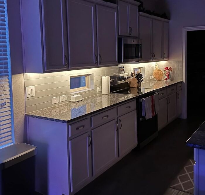 Modern kitchen with granite countertops and under-cabinet lighting showcasing quick home upgrades for weekend wins.