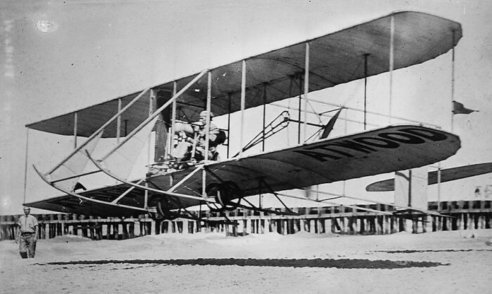 Vintage photo of an early plane model in flight, capturing the magic of aviation with historic aircraft design.