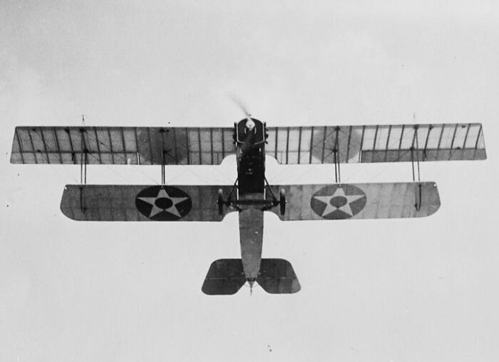 Vintage photo of a biplane in flight showcasing the early magic of aviation during historic aviation times.