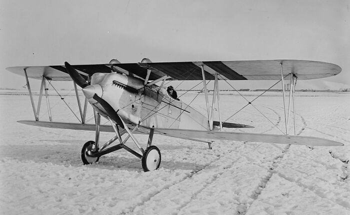 Vintage plane on snowy ground showing classic design and capturing the magic of aviation history and early flight.