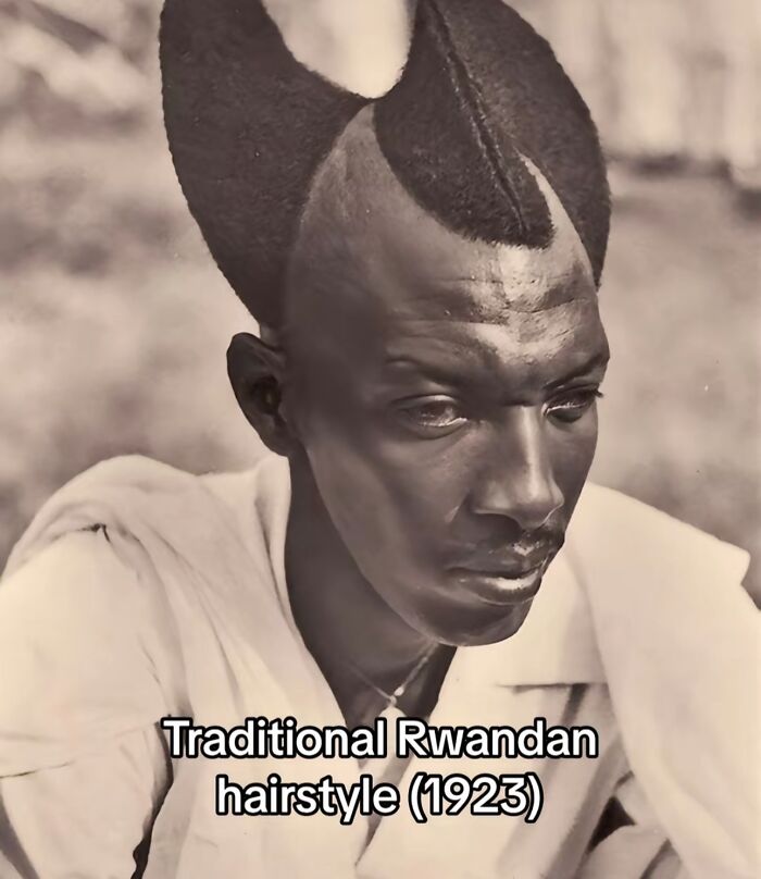 Black and white photo of a man with a traditional Rwandan hairstyle, a monumental life moment frozen in time.
