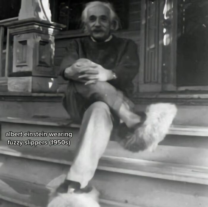 Black and white photo of Albert Einstein wearing fuzzy slippers, a monumental life moment frozen in history.