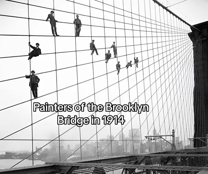 Painters suspended on Brooklyn Bridge cables in 1914 capturing monumental life moments frozen in time.