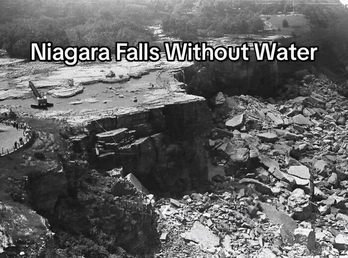 Niagara Falls drained of water, showing rocky riverbed and construction equipment in a monumental life moment frozen in time.