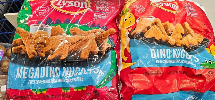 Two bags of Tyson dinosaur-shaped chicken nuggets showing product packaging of smaller and more expensive products.