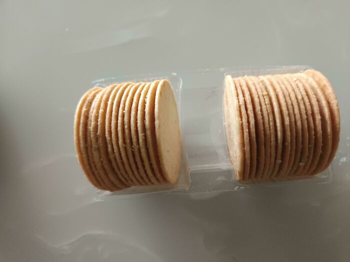 Stacked crackers in smaller packaging showing products getting smaller and more expensive with reduced quantity per pack.