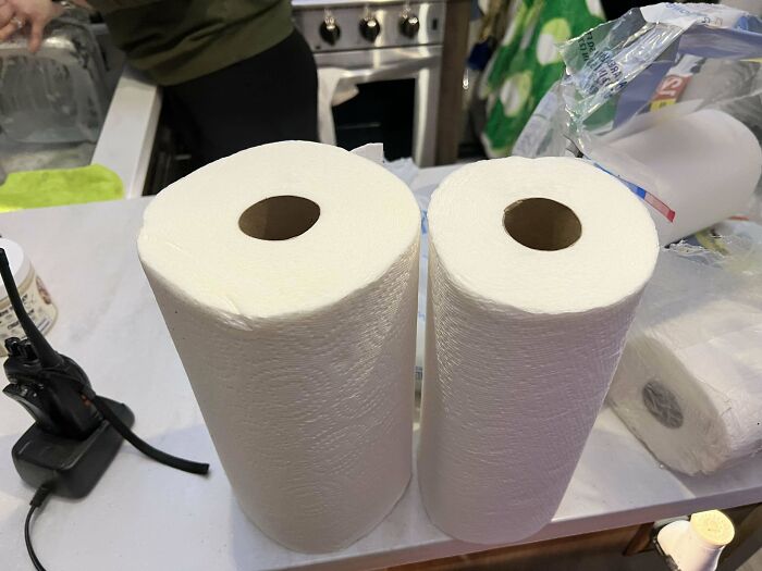 Two rolls of paper towels side by side on a counter showing products getting smaller and more expensive over time