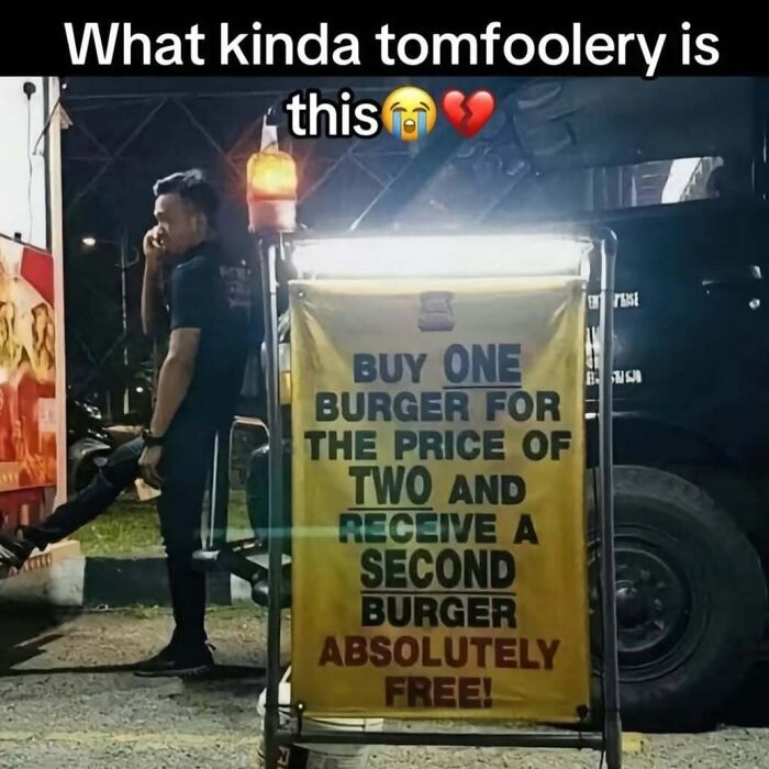 Cringey Instagram post showing a confusing burger deal sign with a man standing nearby at night.