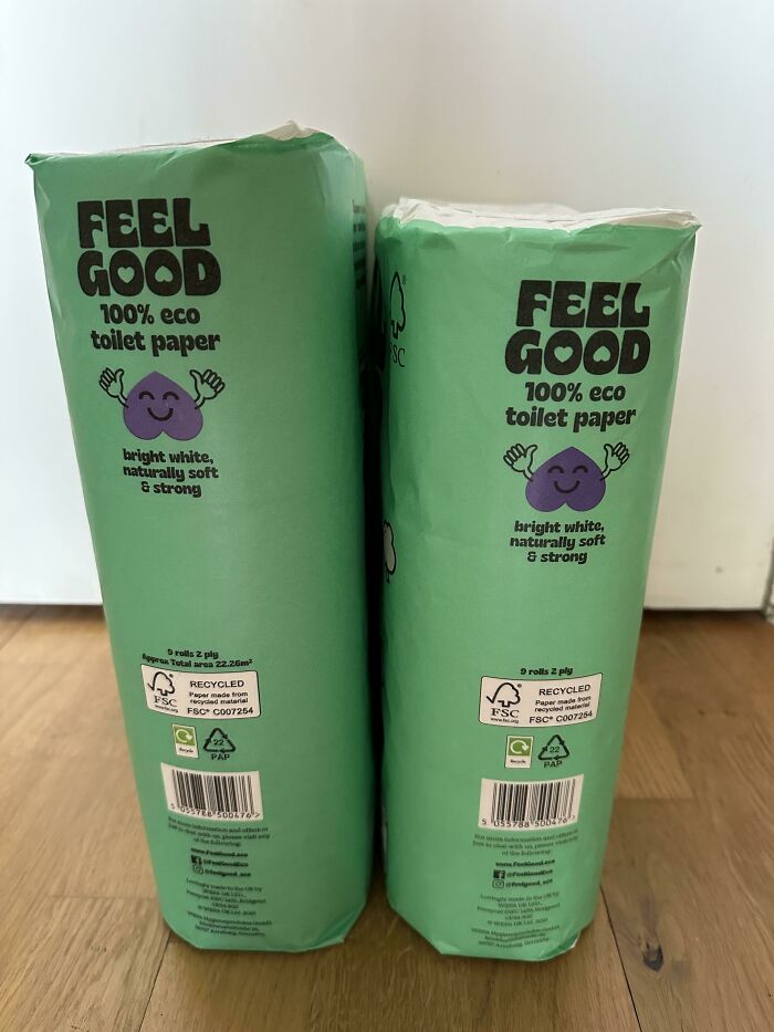 Two smaller packs of Feel Good 100% eco toilet paper placed side by side on a wooden floor highlighting product size changes.