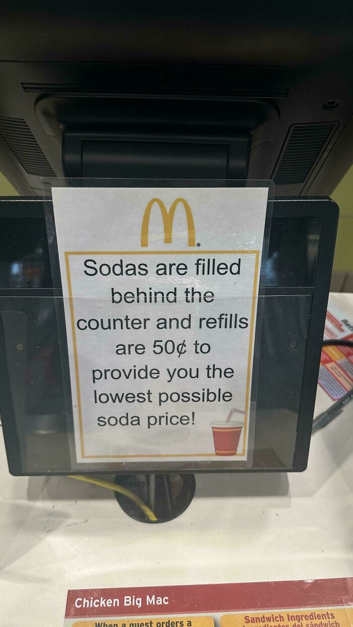 McDonald’s sign explaining soda refills cost extra, illustrating products getting smaller and more expensive concept.