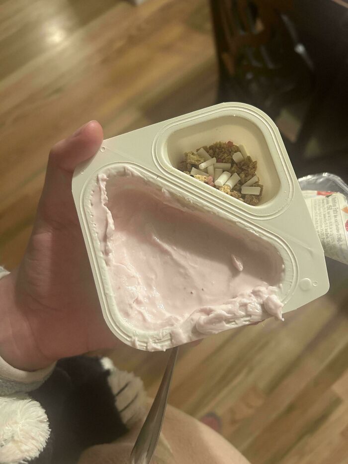 Small yogurt container with minimal granola portion showing products getting smaller and more expensive trend.