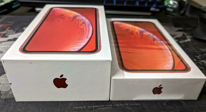 Two sealed iPhone boxes side by side on a dark surface illustrating before and after photos concept.