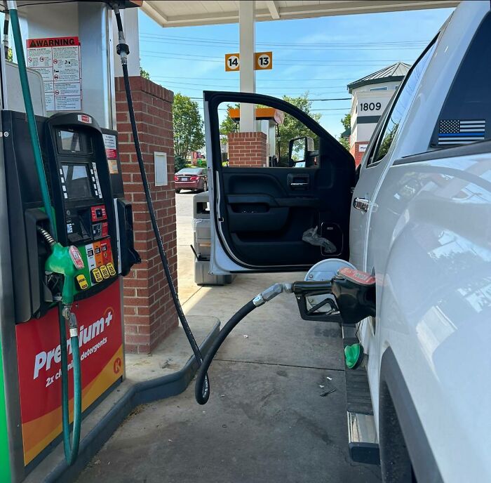 Fuel nozzle left inside the truck’s open door creating an unexpected fail at a gas station pump.