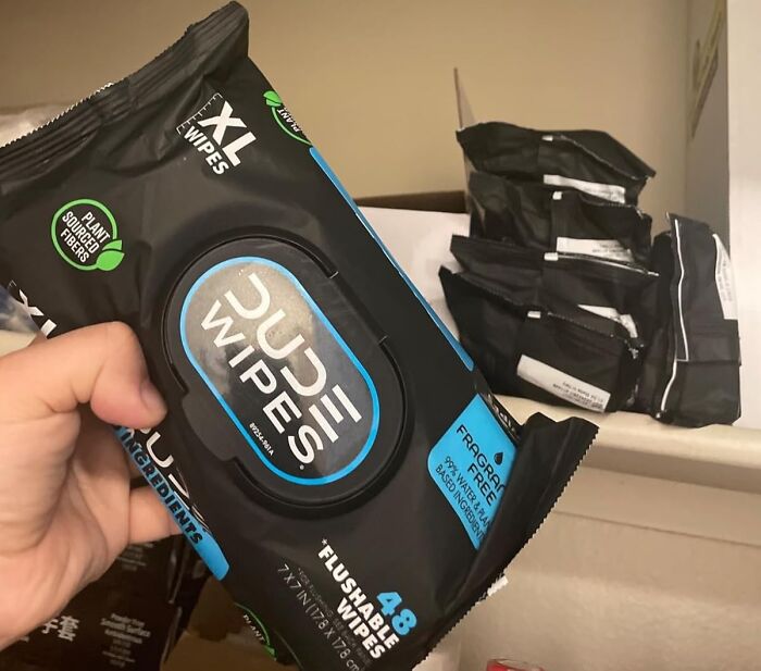 Hand holding a pack of Dude Wipes flushable wipes, one of the popular Shark Tank pitches turned massive hits.