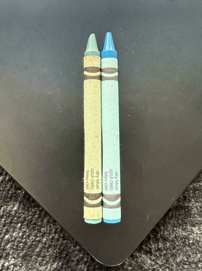 Two sky blue crayons side by side showing before and after colors and wear in a clear comparison photo.