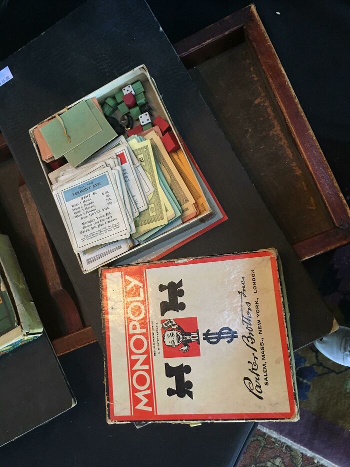 Vintage Monopoly board game with cards, dice, and wooden pieces illustrating how things used to look in the past.