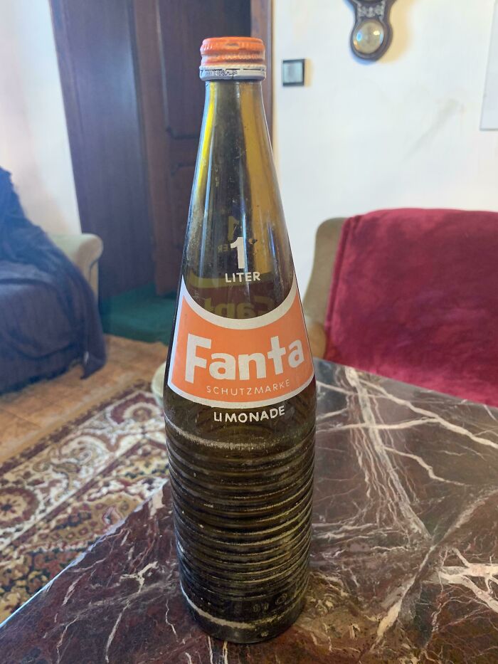 Vintage Fanta glass bottle with classic label on a marble table showcasing how things used to look in retro style.