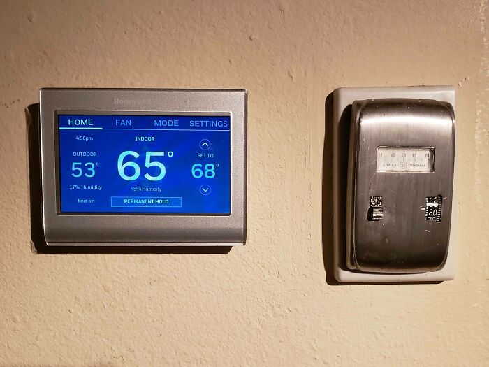 Modern and vintage thermostats side by side illustrating how things used to look compared to current technology.
