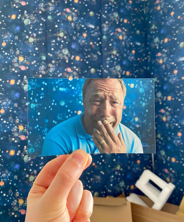 Person holding a photo of a man crying, aligned with a starry background in real-life filming locations comparison.