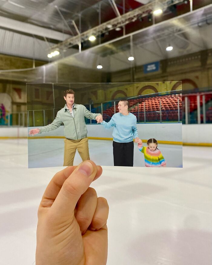 Photo of real-life filming location showing a hand holding a movie scene on an ice rink with characters skating.