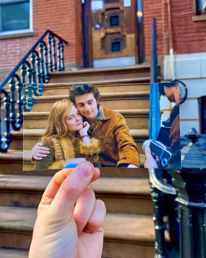 Hand holding a movie scene photo in front of real-life filming location of movie and TV show stairs.
