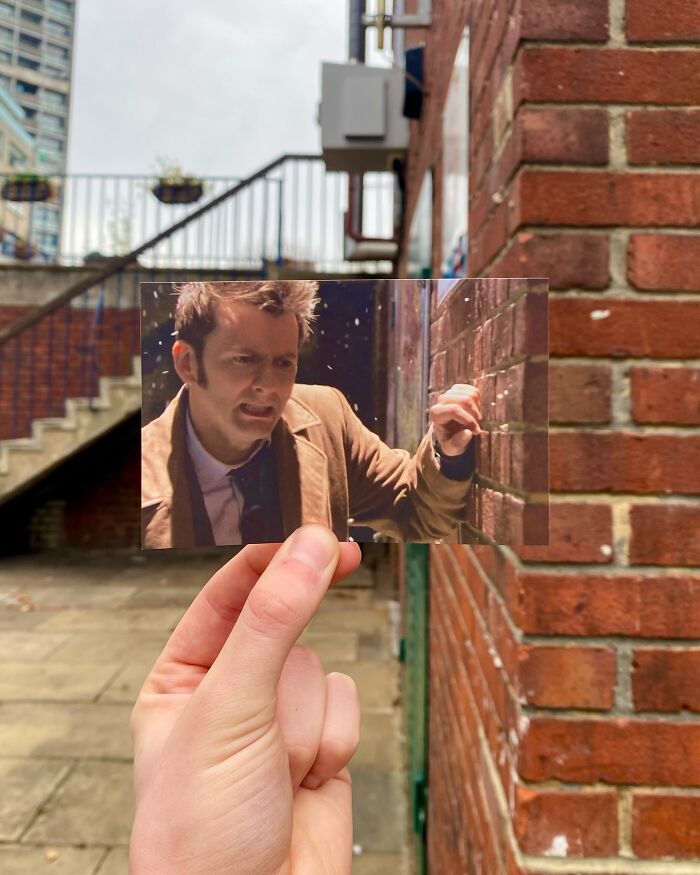 Hand holding a photo matching a real-life filming location of movie and TV show scenes by a photographer.