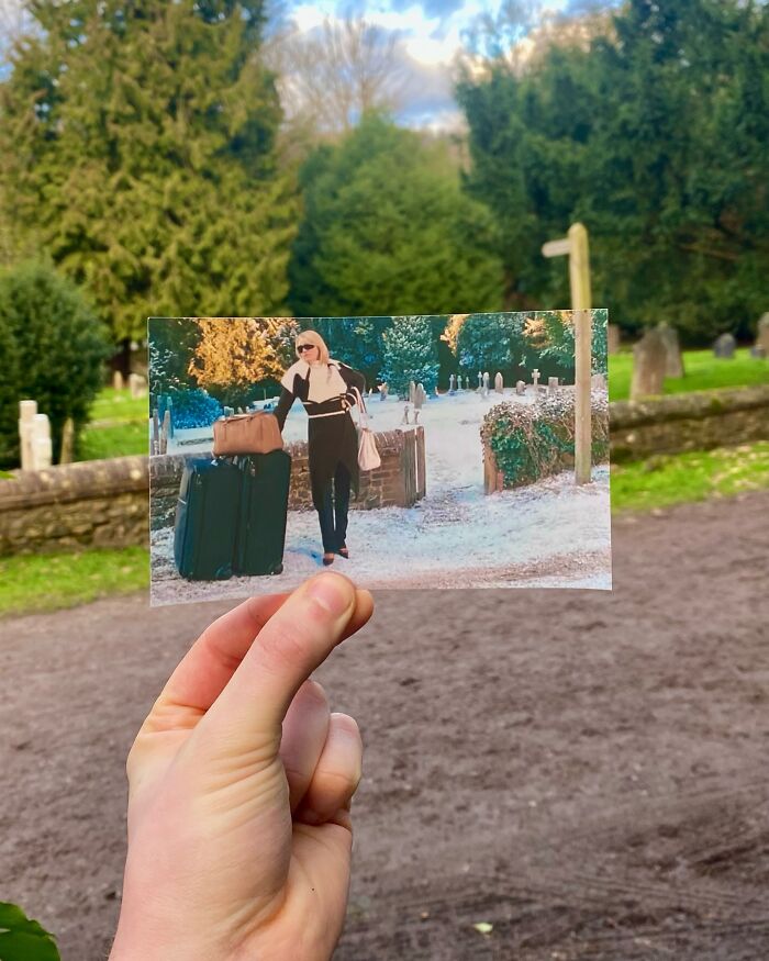 Photo of a real-life filming location where a photographer holds a movie scene photo aligned with the background.