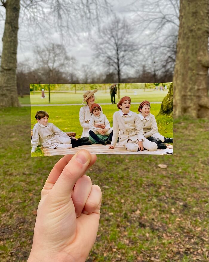 Hand holding photo of children in vintage outfits at a real-life filming location of movie and TV show scenes.