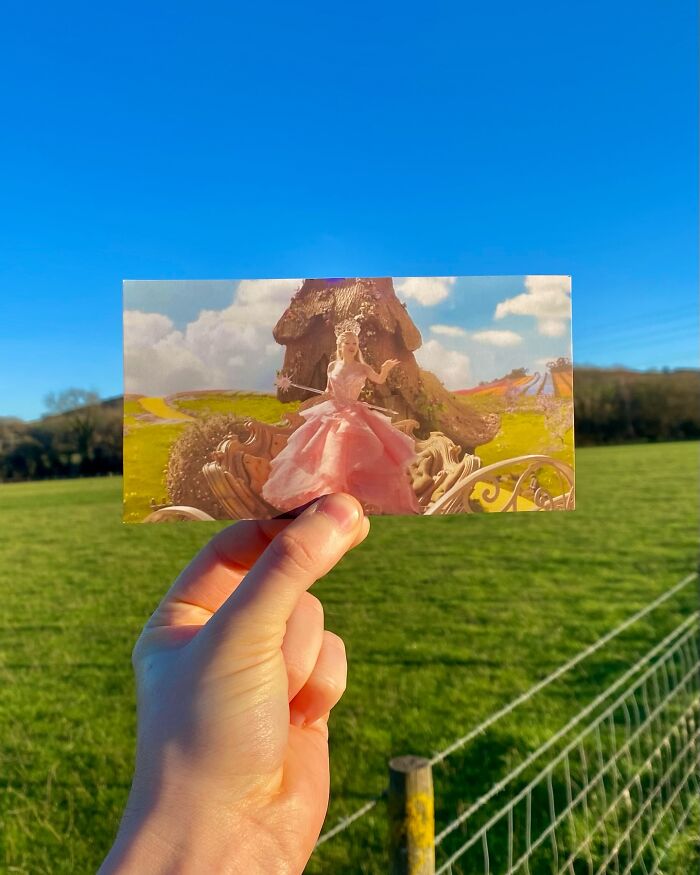 Hand holding a photo of a movie scene with a princess in a pink dress, showing real-life filming locations comparison.