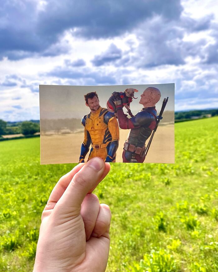 Hand holding a movie scene photo in a green field showing real-life filming locations of movie and TV scenes.