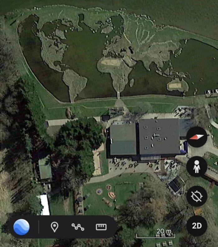 Aerial view of a park with a grass area shaped like a world map, an odd discovery found on Google Earth.