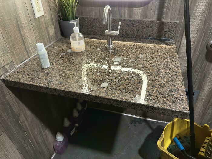 Granite bathroom sink with flat basin design showing poor interior design decision and lack of common sense.