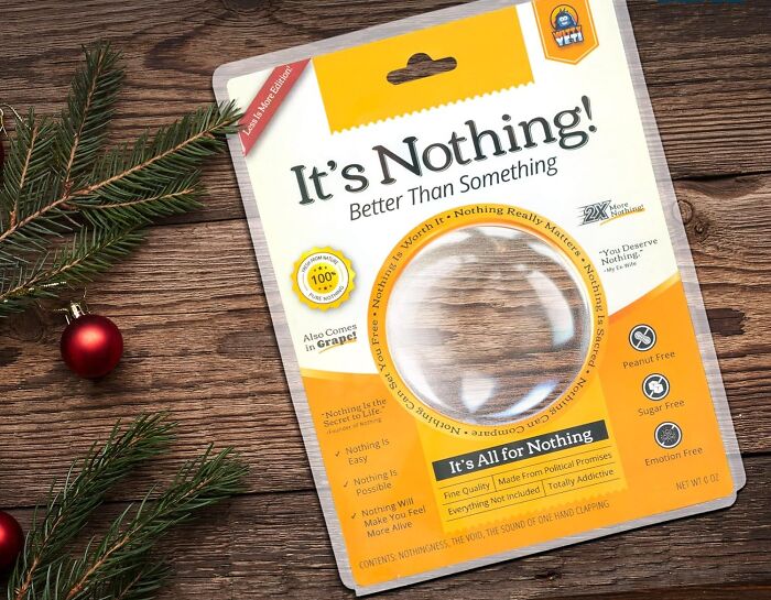 Package of novelty “It’s Nothing” gag gift on wooden table with holiday decorations, a funny find under $10.