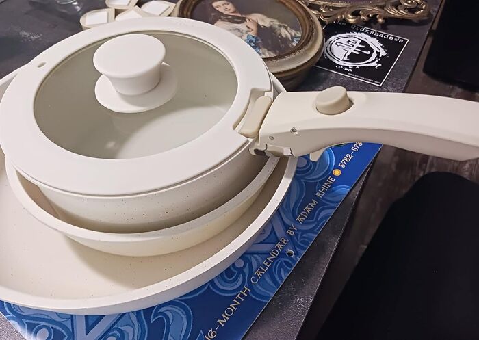 White non-stick pot with lid and handle displayed as an Amazon Memorial Day bargain deal on a table surface.
