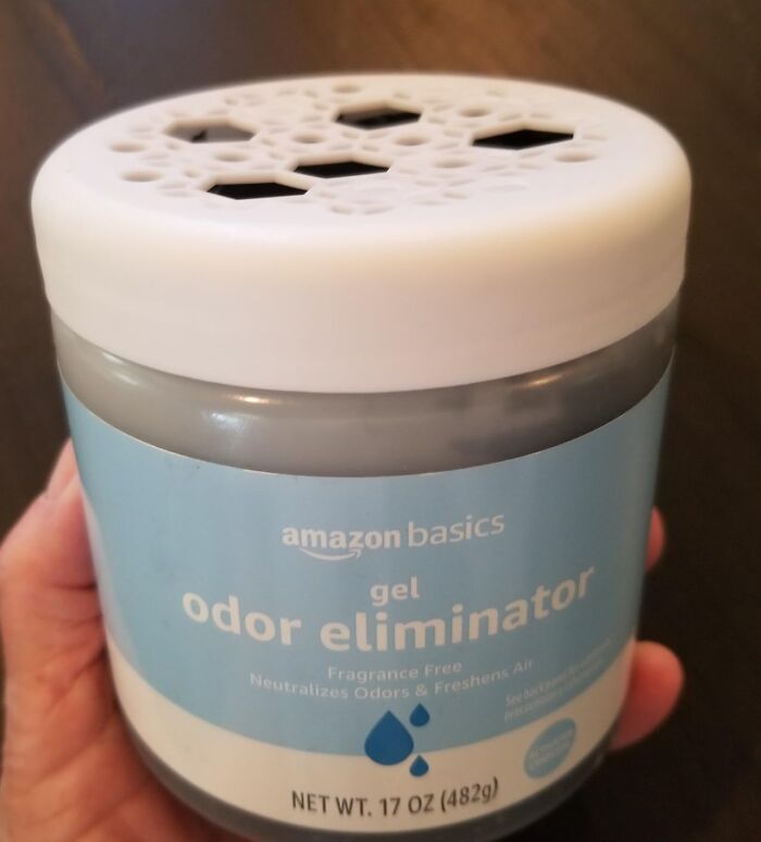 Amazon basics odor eliminator gel in a blue container held by hand, featured in Amazon Memorial Day bargains.