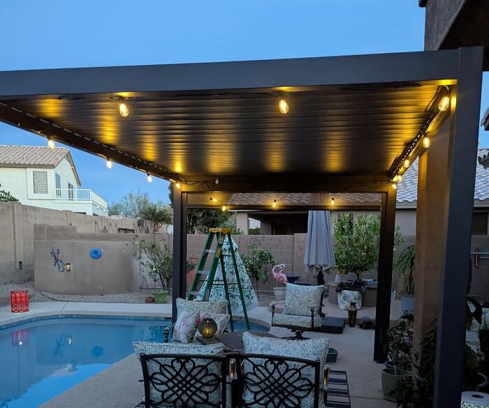 Backyard patio with string lights under cover near pool showcasing Amazon Memorial Day bargains for outdoor living.