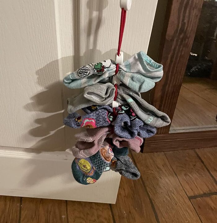 Sock organizer hanging on a door, showcasing an everyday find that helps fix common household annoyances.