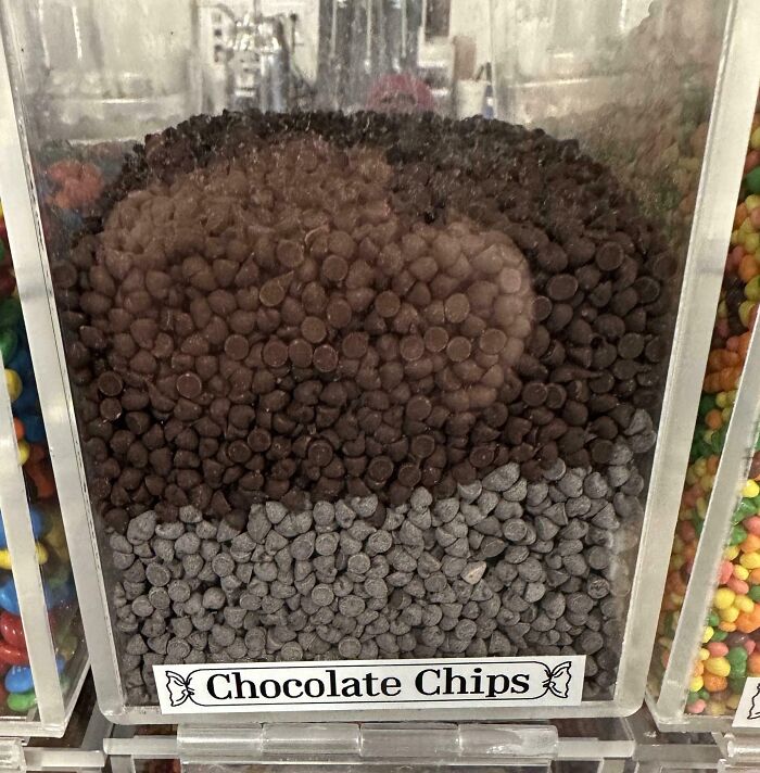Clear plastic container filled with layered chocolate chips in a display, illustrating before and after change.