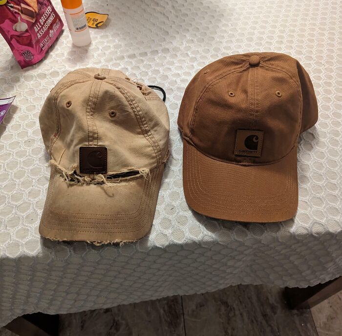 Two Carhartt hats on a table, showing clear before and after photos of wear and restoration.
