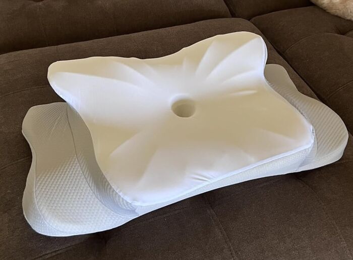 Orthopedic memory foam pillow with ergonomic design and central hole, one of 25 Amazon finds in the Memorial Day sale.