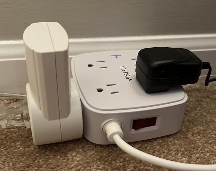 Compact power strip with multiple outlets and plugs connected, ideal for Amazon Memorial Day Sale deals.