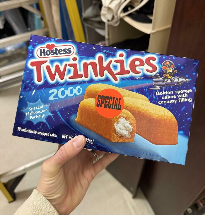 Hand holding a vintage Hostess Twinkies 2000 box, one of the bizarre things found in old houses, labeled special.