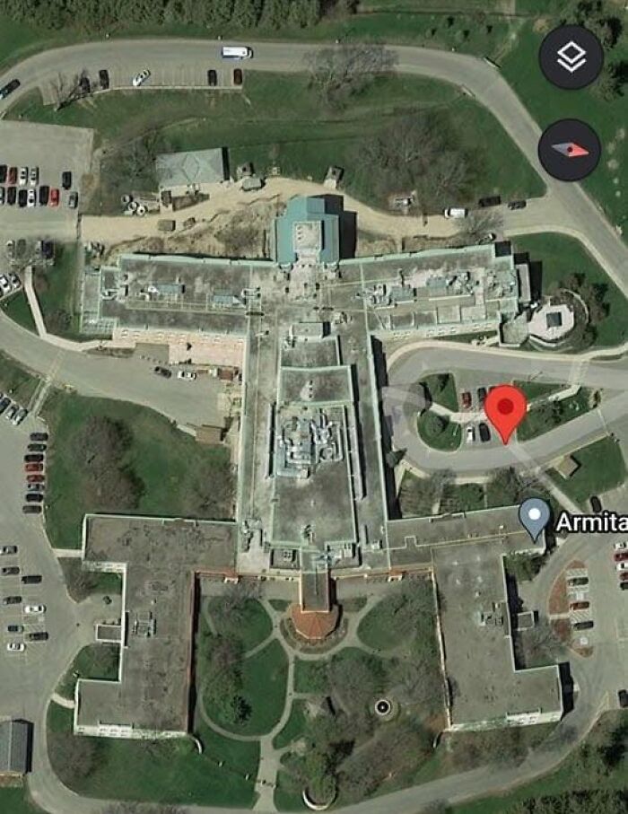 Aerial view of an unusual building shape found on Google Earth with location coordinates visible.