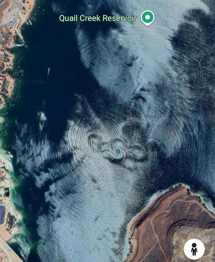 Satellite image of Quail Creek Reservoir showing unusual circular ripple patterns on the water surface, a Google Earth odd find.