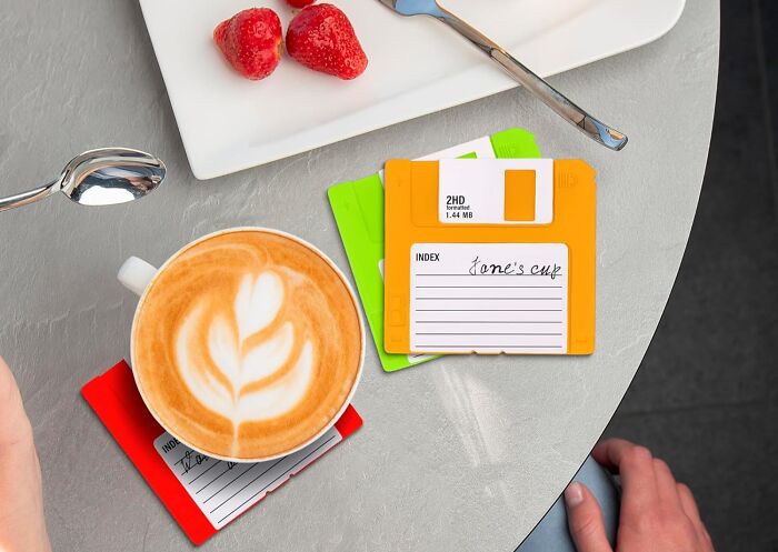 Vintage floppy disk coasters with coffee and strawberries, quirky office humor for a personality transplant with funny finds.